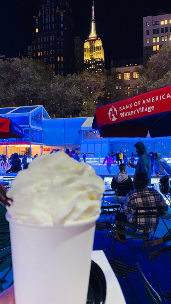 Sip hot chocolate while taking in the view of the Empire State Building in Bryant Park Winter Village